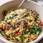 Bowl of Mushroom Spinach Orzo featuring fresh ingredients and vibrant colors.