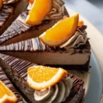 Delicious slice of Orange Chocolate Cheesecake topped with orange zest.