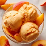 Delicious Peach Greek Yogurt in a bowl topped with fresh peach slices