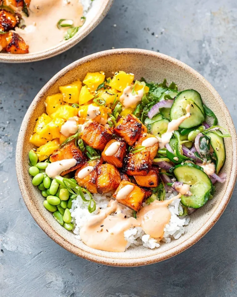 Colorful salmon bowl topped with fresh vegetables and grains