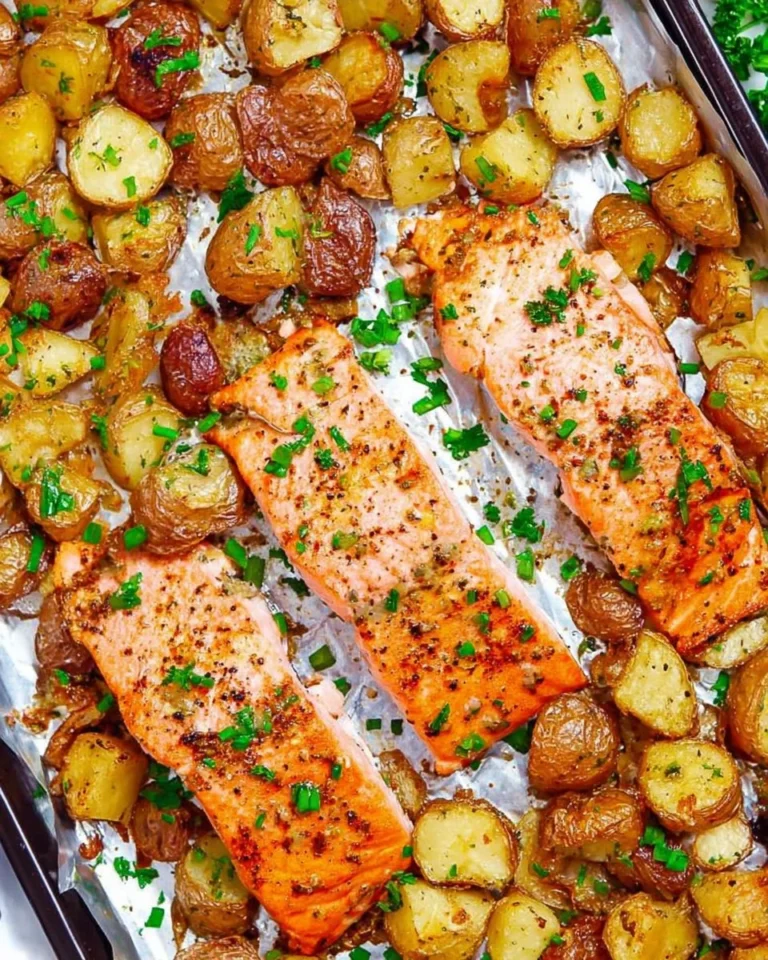 Sheet pan with lemon dijon salmon and potatoes ready to serve