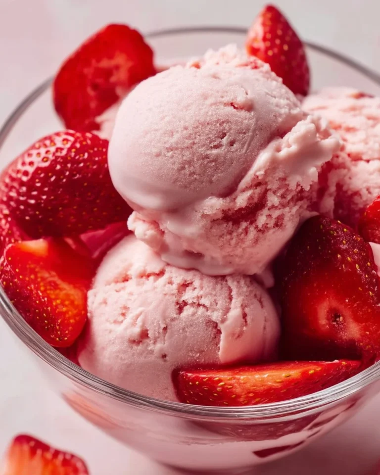 Creamy strawberry Greek frozen yogurt topped with fresh strawberries