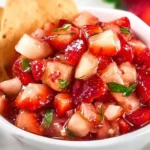 Bowl of vibrant strawberry salsa with fresh ingredients and herbs