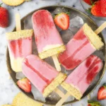 Refreshing strawberry shortcake popsicles on a sunny outdoor setting