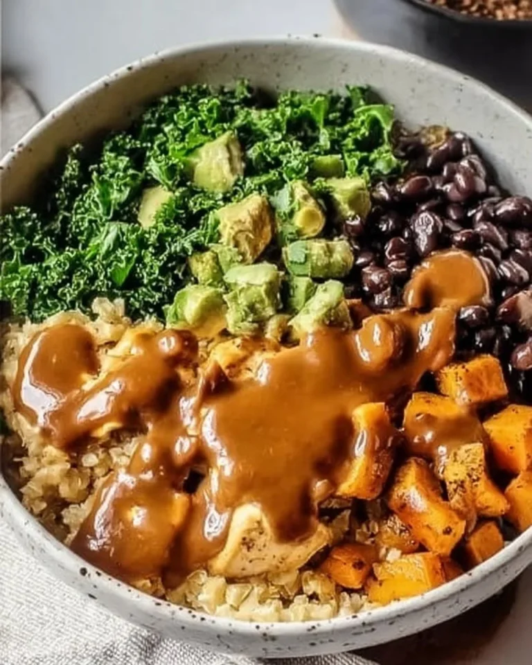 Delicious Thai Peanut Sweet Potato Buddha Bowl topped with fresh vegetables