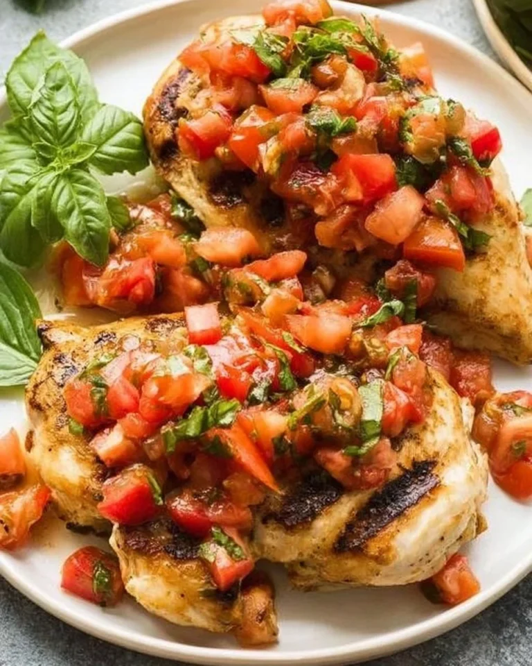 Bruschetta Chicken with fresh tomatoes and basil prepared on a plate.