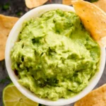 Bowl of homemade Chipotle-style guacamole with fresh ingredients