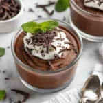 Delicious chocolate avocado pudding served in a bowl, garnished with fresh mint leaves.