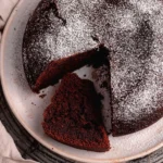 Delicious Chocolate Olive Oil Cake topped with chocolate glaze and fresh berries