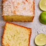 Delicious Coconut Lime Loaf Cake topped with coconut flakes and lime zest