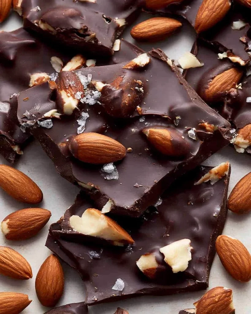 Delicious dark chocolate almond bark with crunchy almonds in a rich chocolate setting.