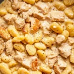Delicious plate of Gnocchi Carbonara topped with parmesan and black pepper