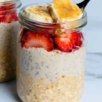 High-protein overnight oats in a bowl topped with fruits and nuts