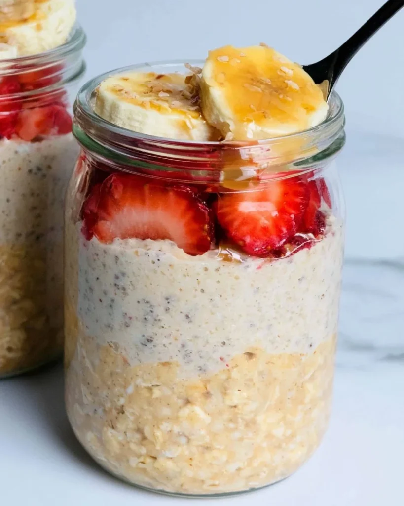 High-protein overnight oats in a bowl topped with fruits and nuts