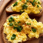 Bowl of high-protein scrambled eggs with cottage cheese and herbs
