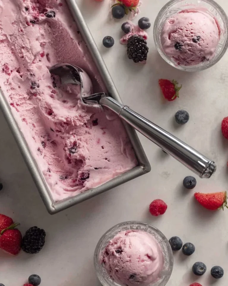 Delicious homemade berry frozen yogurt served in a bowl with fresh berries on top