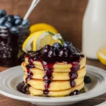 Fluffy Lemon Ricotta Pancakes topped with fresh fruit and syrup