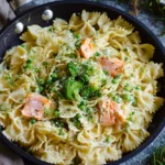 Creamy salmon pasta with crème fraîche garnished with herbs