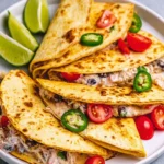 Plate of quick and flavorful shredded chicken tacos with fresh toppings