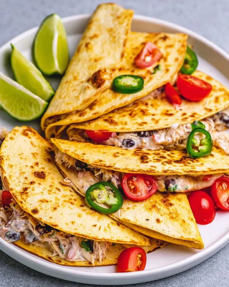 Plate of quick and flavorful shredded chicken tacos with fresh toppings