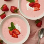 Bowl of delicious homemade strawberry soup topped with fresh mint leaves