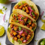 Delicious tofu tacos garnished with fresh vegetables and spices