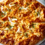 Delicious Buffalo Chicken Pizza with spicy sauce, cheese, and toppings.