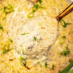 Delicious bowl of homemade Cheeseburger Soup with cheese and toppings