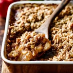 Delicious Classic Apple Crisp topped with ice cream served in a bowl