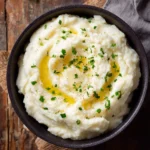 Creamy Cottage Cheese Mashed Potatoes served in a bowl, garnished with herbs.