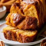 Easy pumpkin spice pull-apart bread topped with cinnamon sugar in a rustic setting.