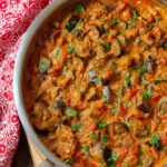 Delicious bowl of Eggplant Curry served with rice and garnished with cilantro.