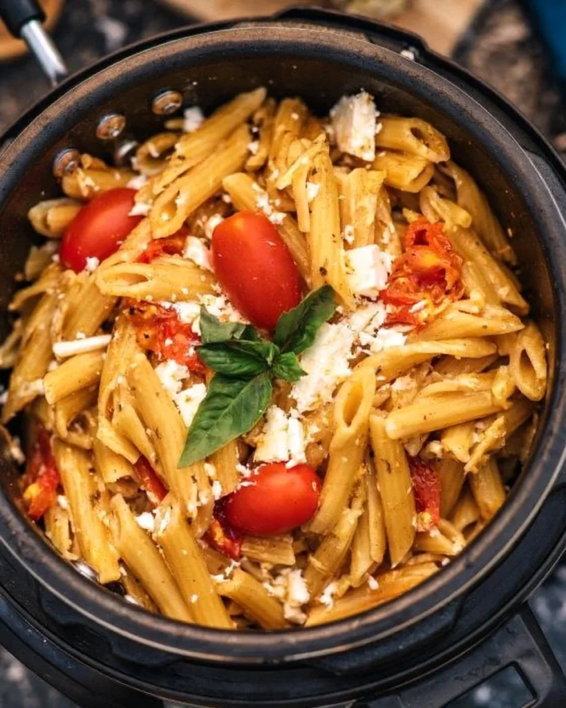 Delicious feta and tomato pasta dish prepared with fresh ingredients.