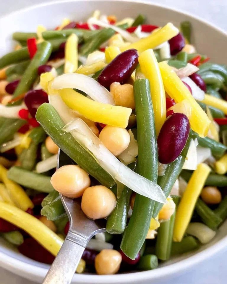 Bowl of vibrant four bean salad with mixed vegetables and dressing