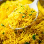 Delicious Garlic Turmeric Rice served in a bowl with herbs and spices