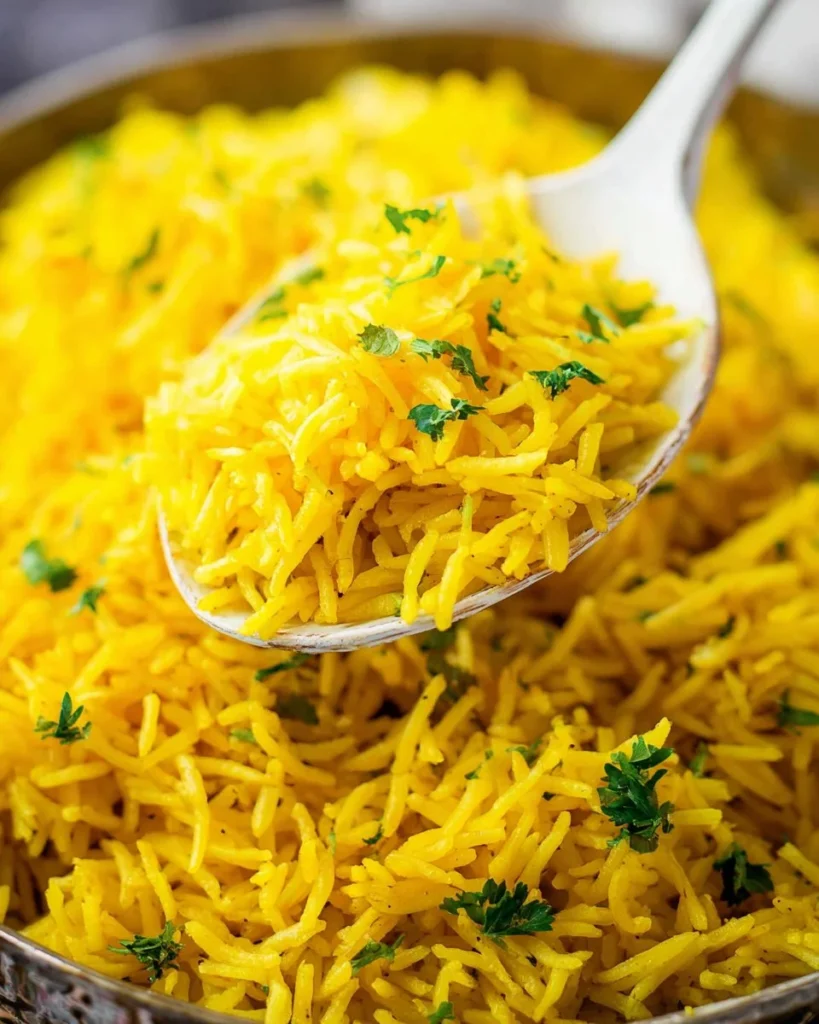 Delicious Garlic Turmeric Rice served in a bowl with herbs and spices