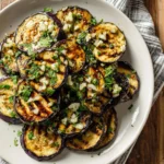 A delicious plate of grilled eggplant garnished with herbs