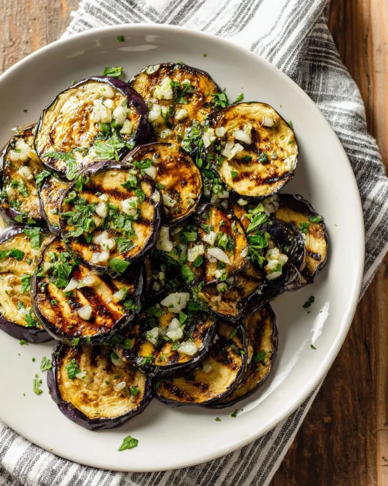 A delicious plate of grilled eggplant garnished with herbs