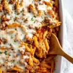 Delicious ground beef casserole topped with cheese and served in a baking dish.