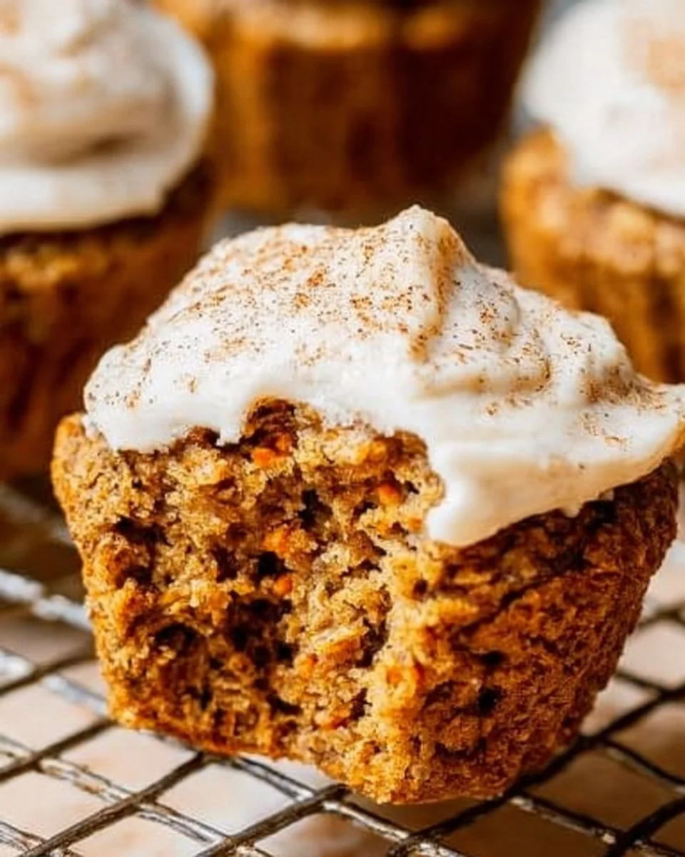 Freshly baked healthy carrot cake muffins topped with nuts and spices