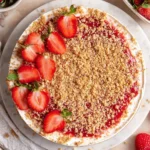 No Bake Strawberry Crunch Cheesecake topped with fresh strawberries and crunch.