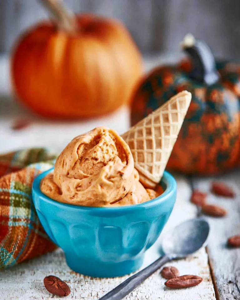 A bowl of creamy Pumpkin Ice Cream topped with cinnamon, perfect for fall.