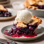 Spiced blueberry pie garnished with cinnamon and served on a rustic plate